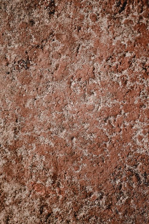 Free Detailed close-up of natural stone texture with earthy tones, ideal for backgrounds. Stock Photo