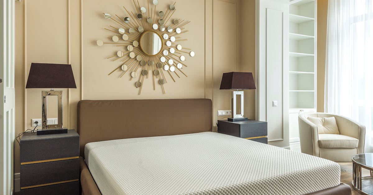 Elegant modern bedroom featuring minimalist design with unique mirror art above the bed.