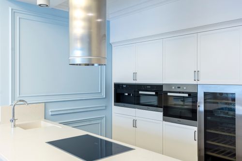 Free A sleek and contemporary kitchen featuring built-in ovens and a minimalist design with ample cabinet space. Stock Photo