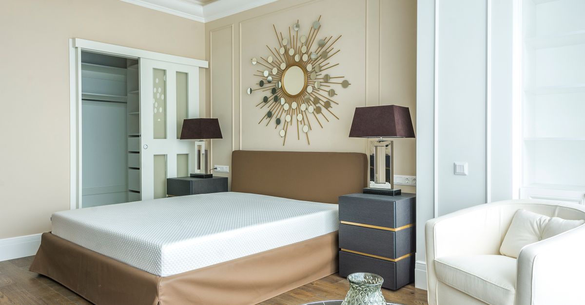 cozy minimalist bedroom with neutral tones, soft lighting, and a neatly organized closet