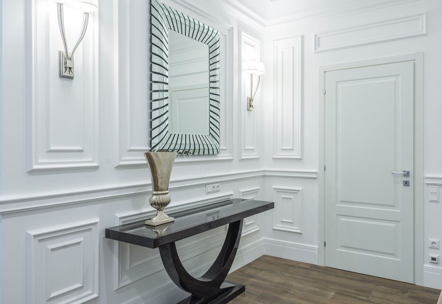 Hallway with a mirror, console, and wall lights, photo by Max Vakhtbovych on Pexels