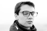 Monochrome Photo of a Man with Eyeglasses Closing His Eyes