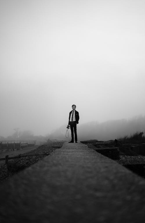 A Man Standing on Concrete