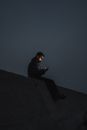 Man in Black Jacket Sitting on the Ground