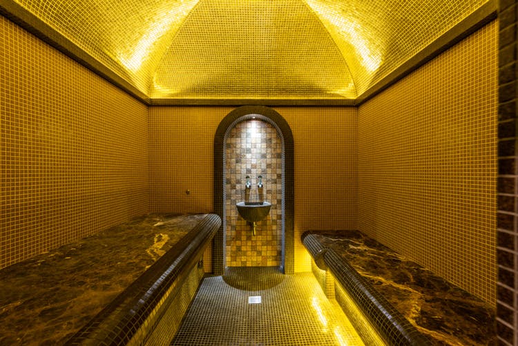 Bathhouse Interior With A Sink And Seats