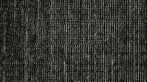 Close-up of dark fabric texture showcasing intricate weave patterns.