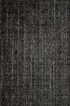Close-up of dark fabric texture showcasing intricate weave patterns.