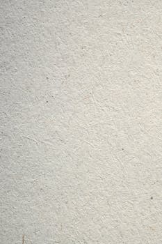 Closeup of a minimalist white textured paper background, ideal for design projects.