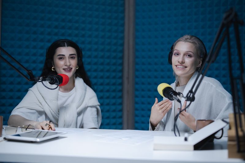 Two hosts talking in a podcast studio — photo by cottonbro studio on Pexels