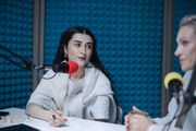 Host speaking into a studio microphone — photo by cottonbro studio on Pexels