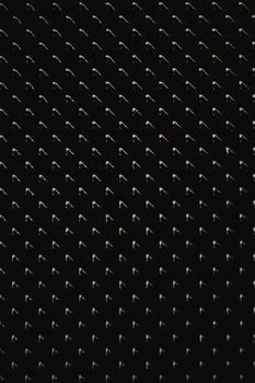 Artistic abstract black surface with repeating geometric pattern and smudges for modern designs.