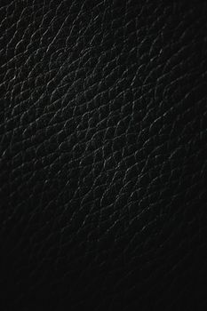 Close-up of a detailed black leather texture ideal for use as a background or pattern.