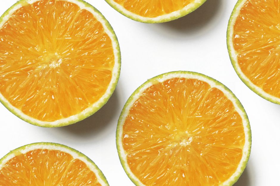Vibrant slices of fresh oranges on a clean white backdrop, showcasing juicy citrus appeal.
