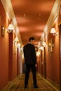 Man in Black Suit Standing in Hallway