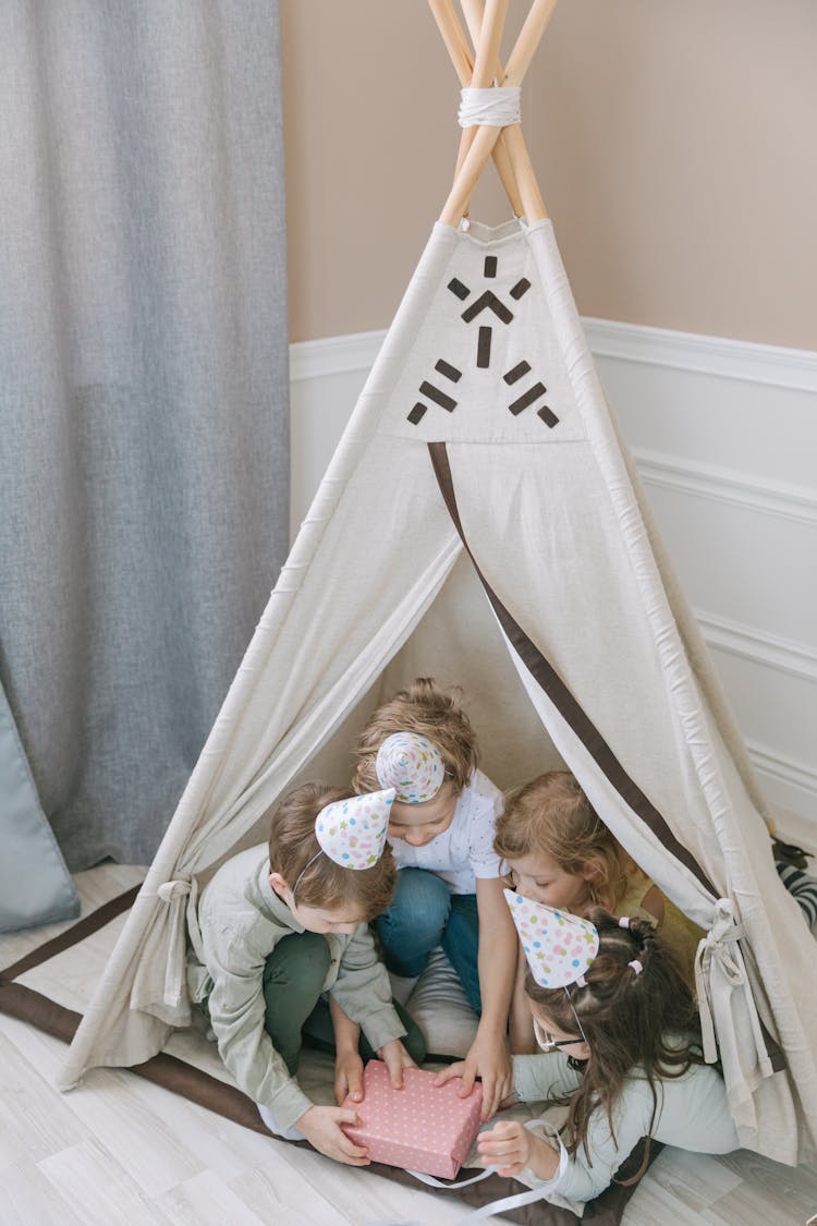 Kids Inside A Tent Opening A Present