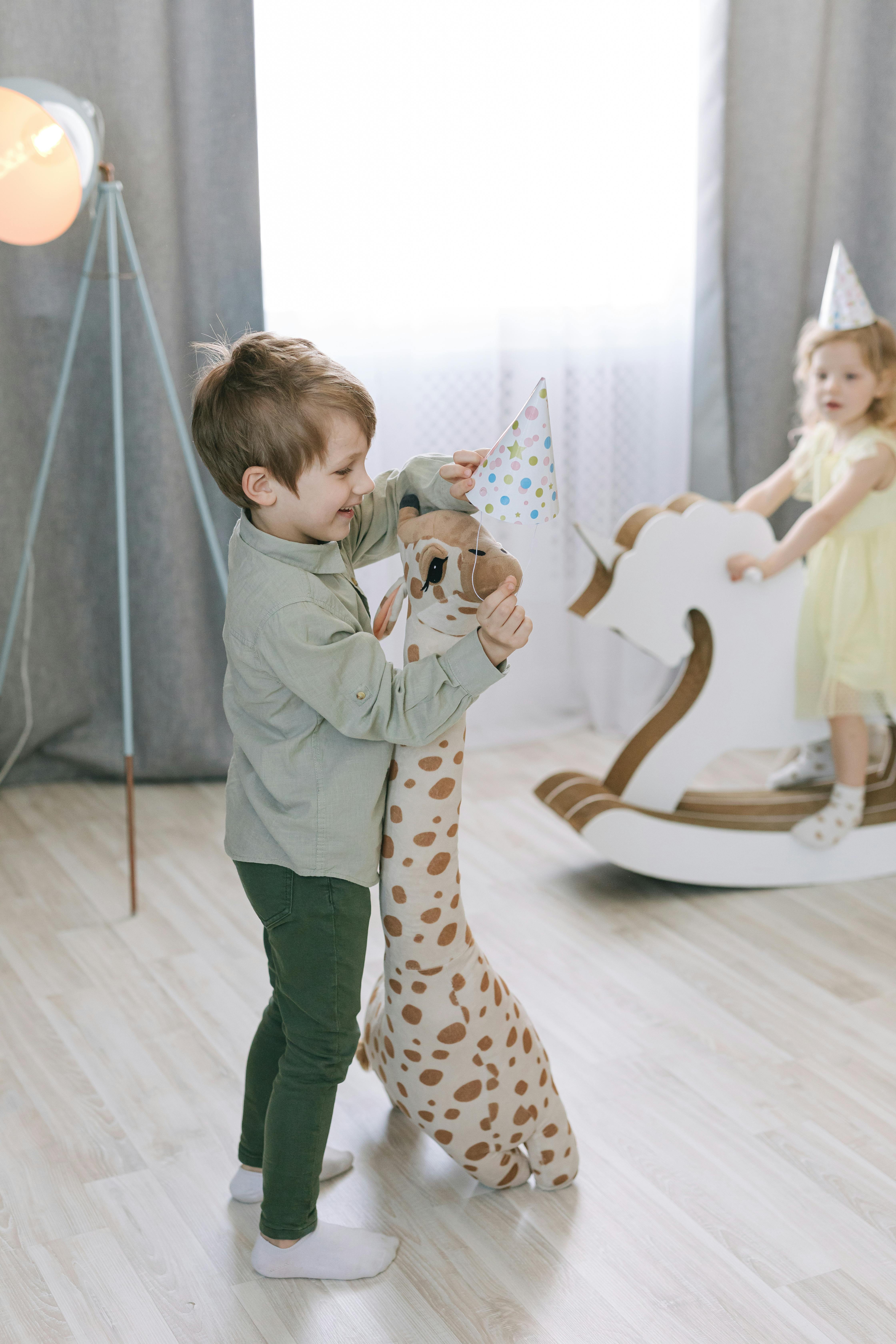 a boy playing with a stuffed toy