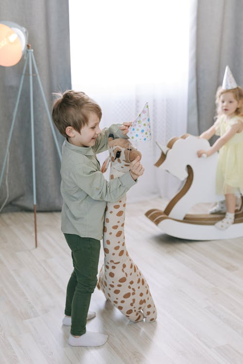 A Boy Playing with a Stuffed Toy