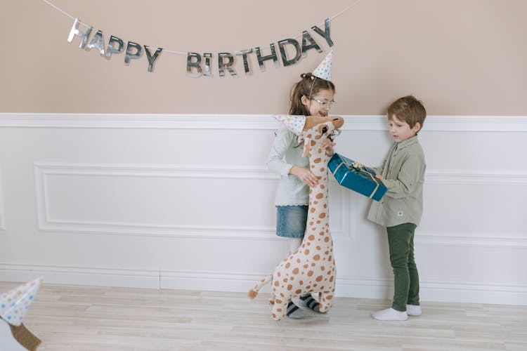 A Boy In Long Sleeves Shirt Holding A Gift