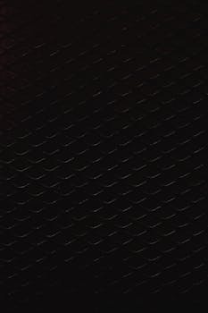 Intricate vertical wire mesh pattern with dark tone creating a unique abstract background.