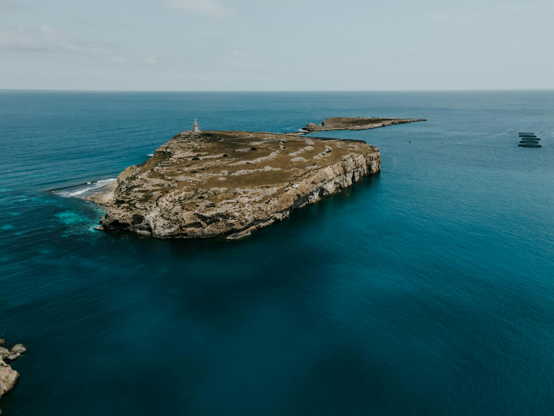 Stunning drone shot of Mellieha's rocky coastline and blue sea in Malta, perfect for travel inspiration.