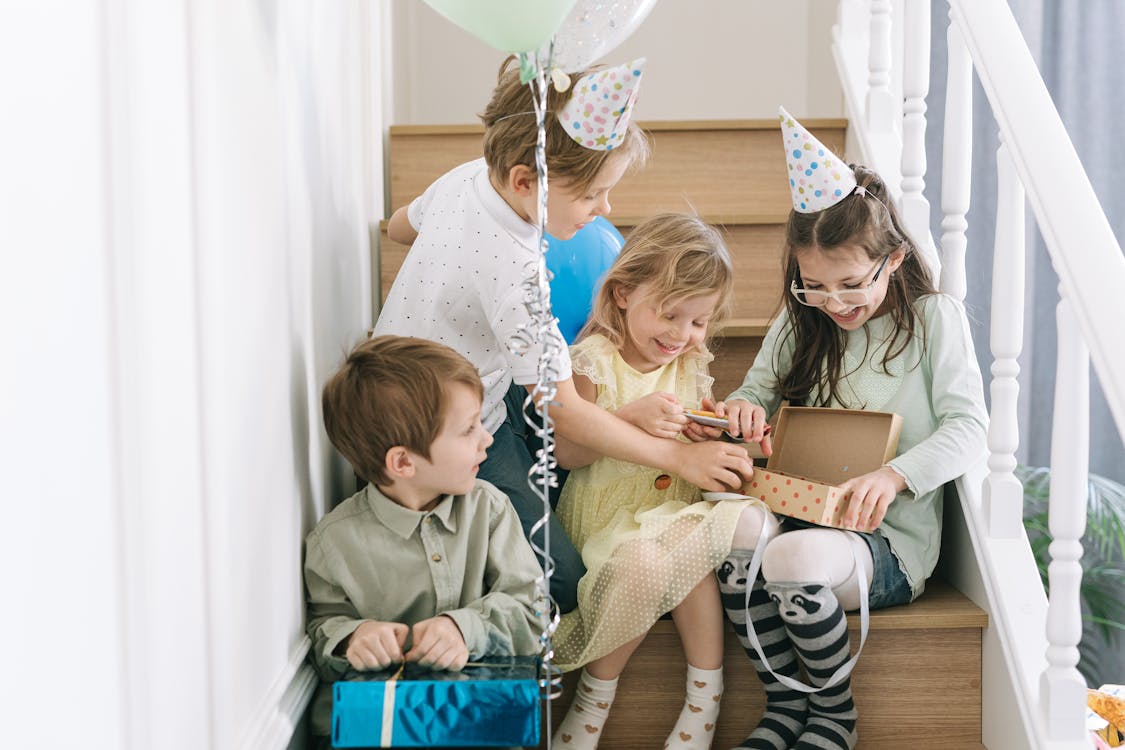 Free Children Opening Gifts on the Staircase Stock Photo