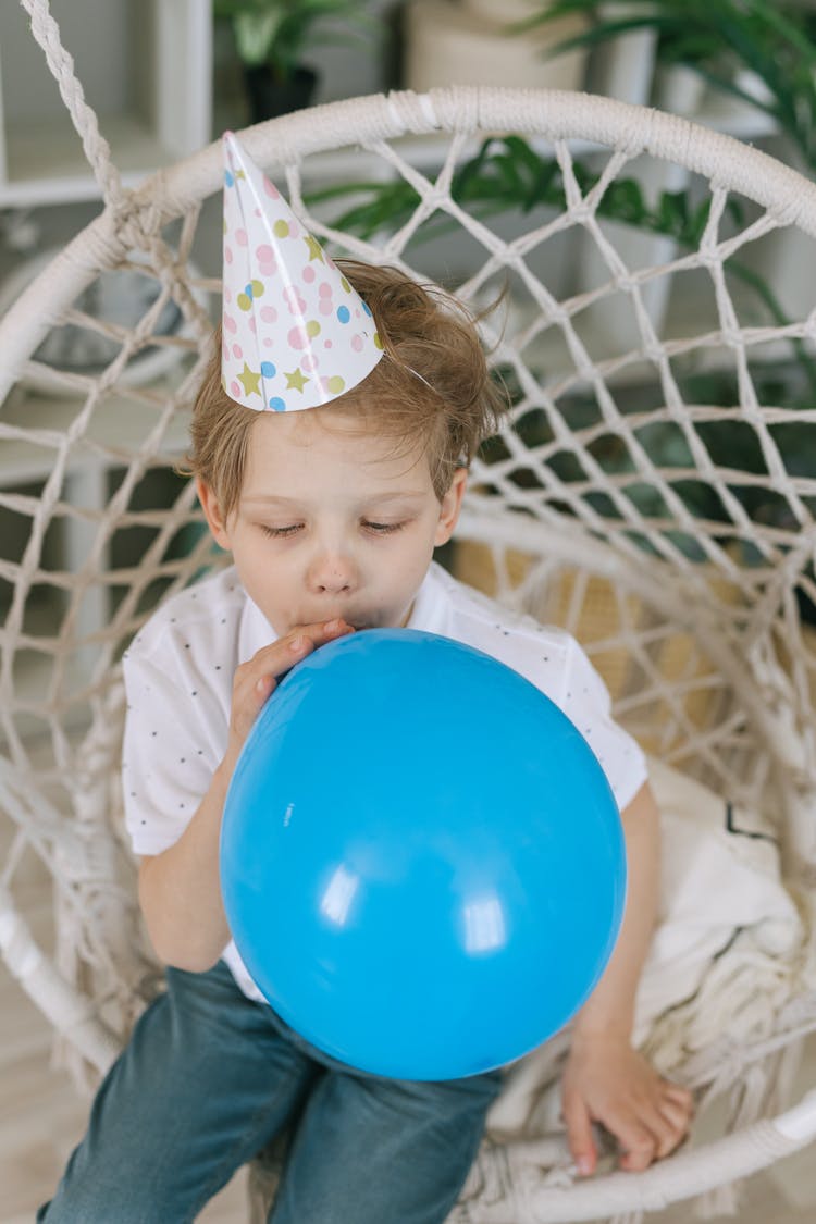 A Boy Blowing Balloon