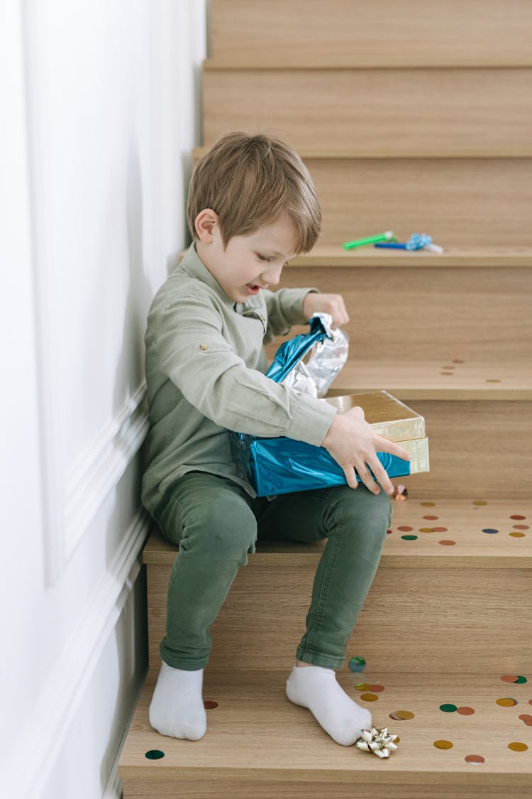 A Boy Opening His Gift