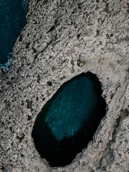 Stunning aerial photo of a natural rock formation with ocean in Il-Mellieħa, Malta.
