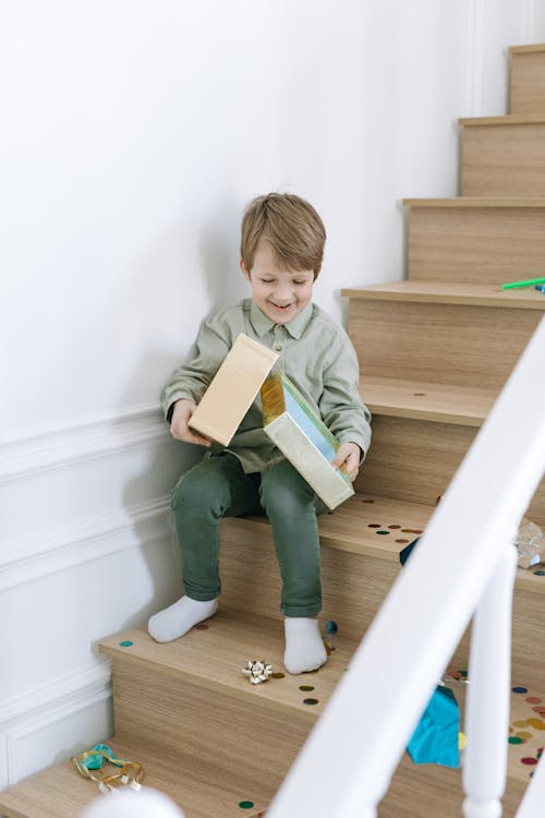 Free A Boy Sitting on the Wooden Stairs Stock Photo
