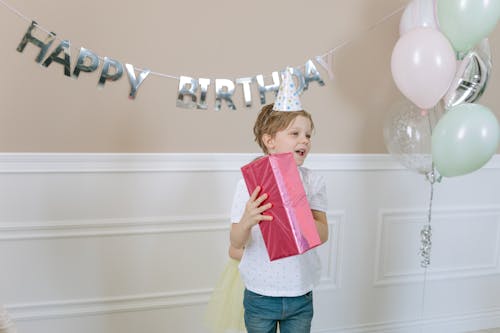 Free Boy Holding a Gift Stock Photo