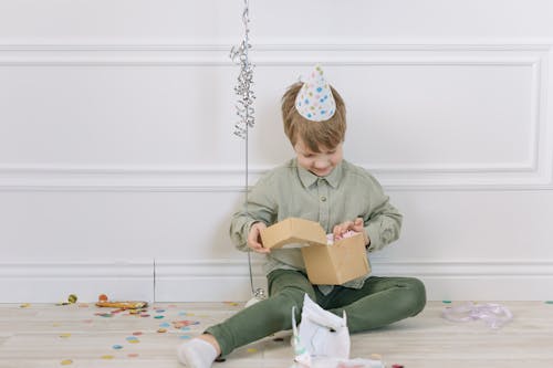 Free Smiling Boy Opening a Present Stock Photo