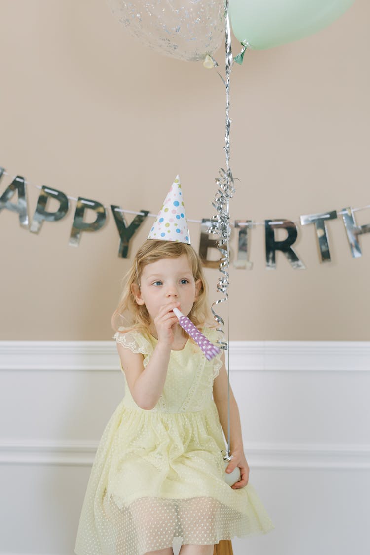 A Girl Wearing A Party Hat 