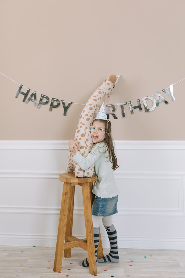 A Girl Hugging A Stuffed Animal 