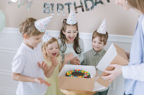 Free Kids Clapping Beside a Birthday Cake Stock Photo
