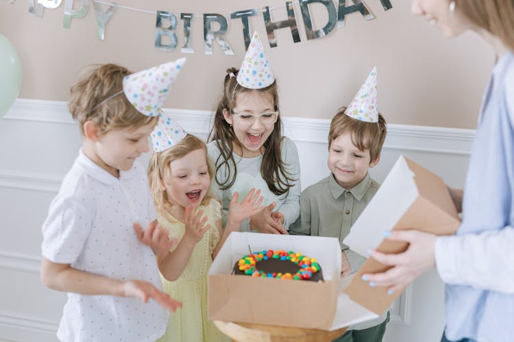 Kids Clapping Beside A Birthday Cake