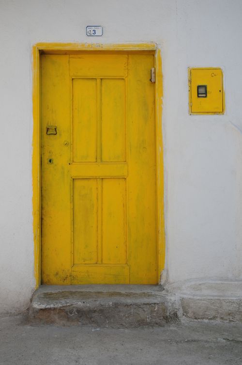Free Yellow wooden door and wall detail in Osmaneli, capturing vibrant architecture. Stock Photo