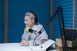 Host laughing at a studio microphone — photo by cottonbro studio on Pexels