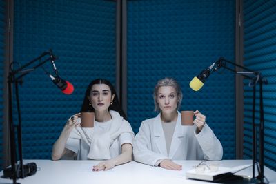 Two presenters seated at studio microphones — photo by cottonbro studio on Pexels