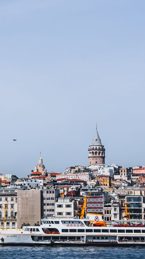 Free Explore Istanbul with a ferry view of Galata Tower and cityscape by the Bosphorus. Stock Photo