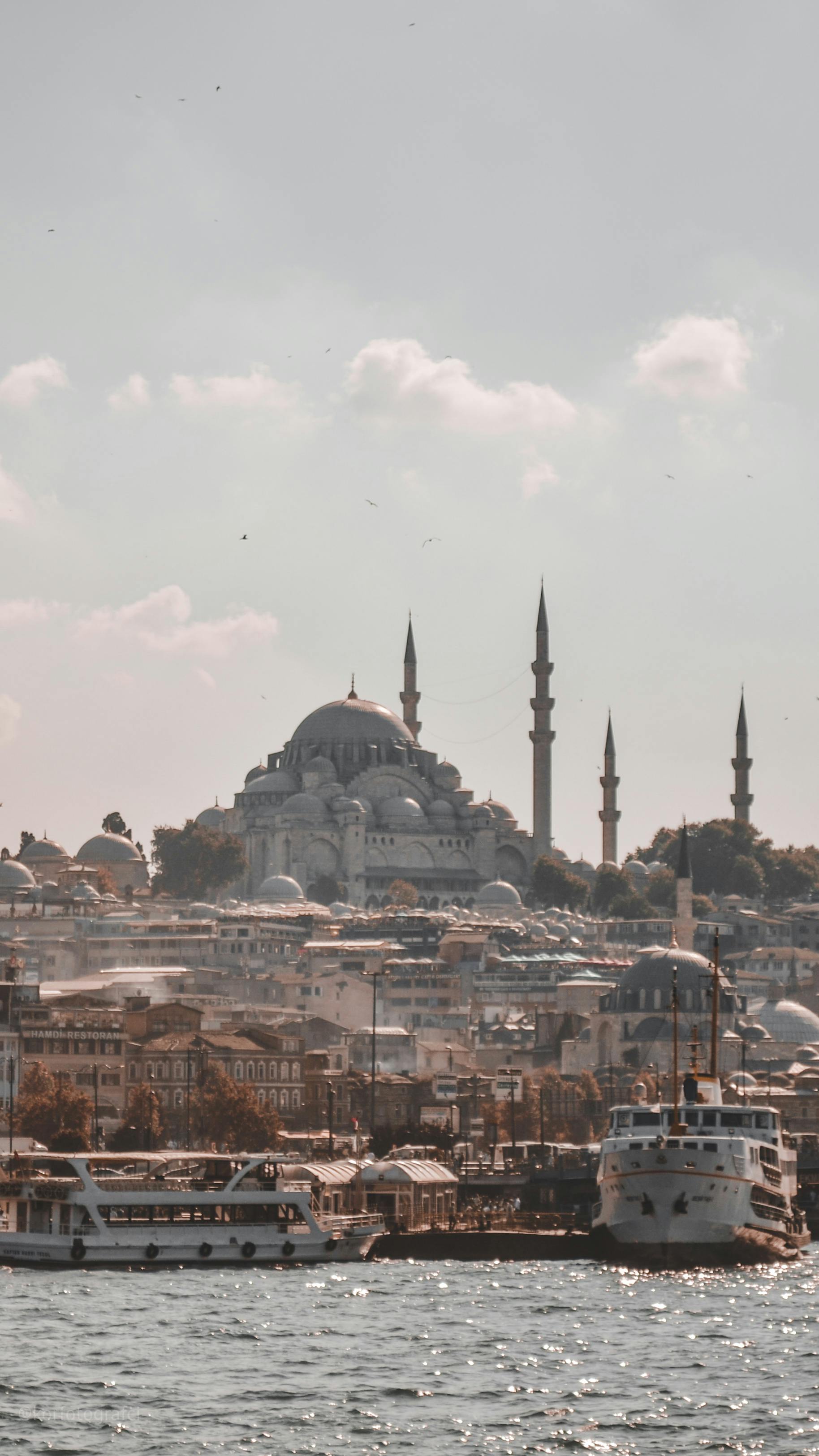 Scenic view of Suleymaniye Mosque and ferry boats on the Bosphorus Strait, Istanbul, Turkey.
