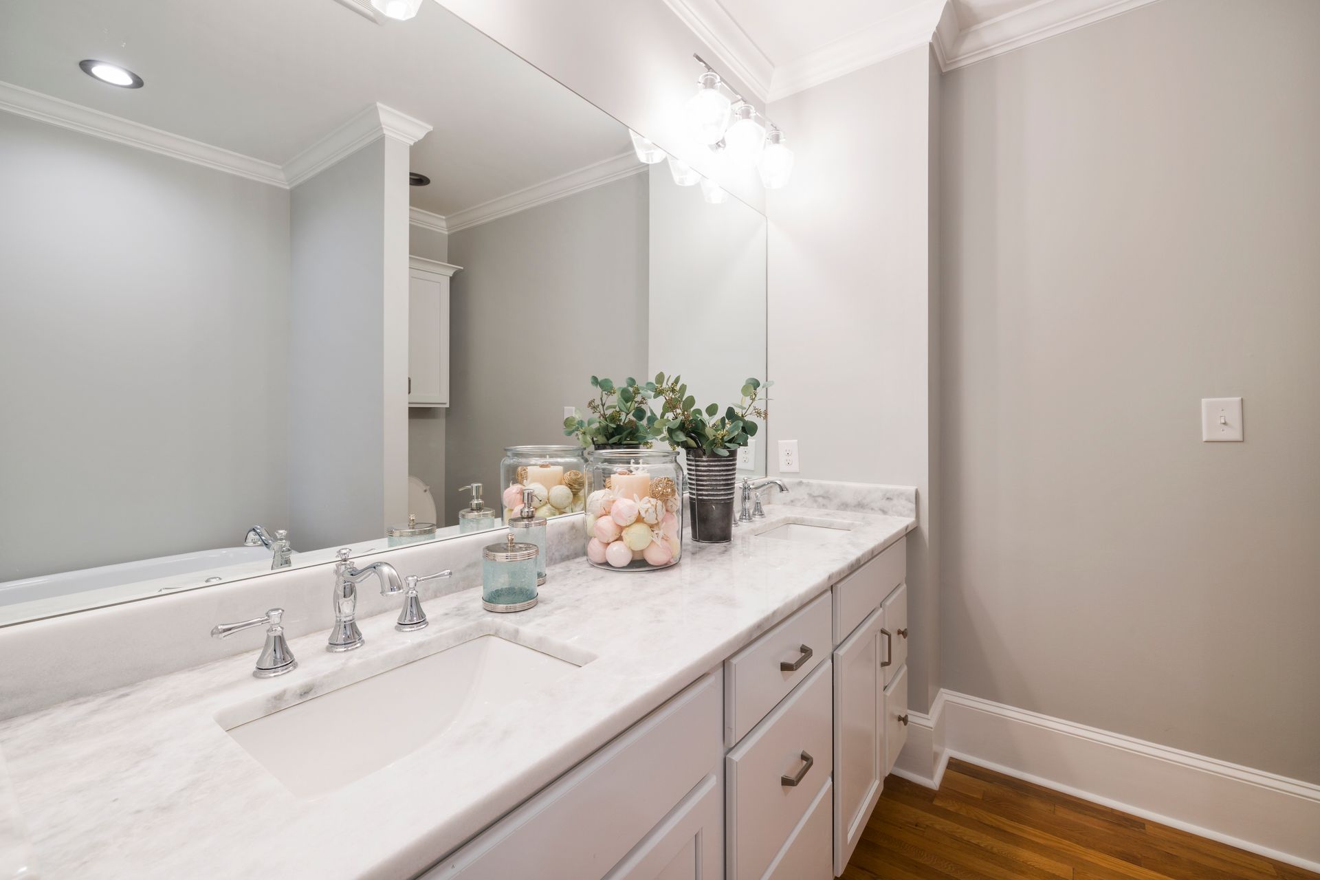Spacious bathroom featuring a stylish marble countertop and elegant modern accessories.