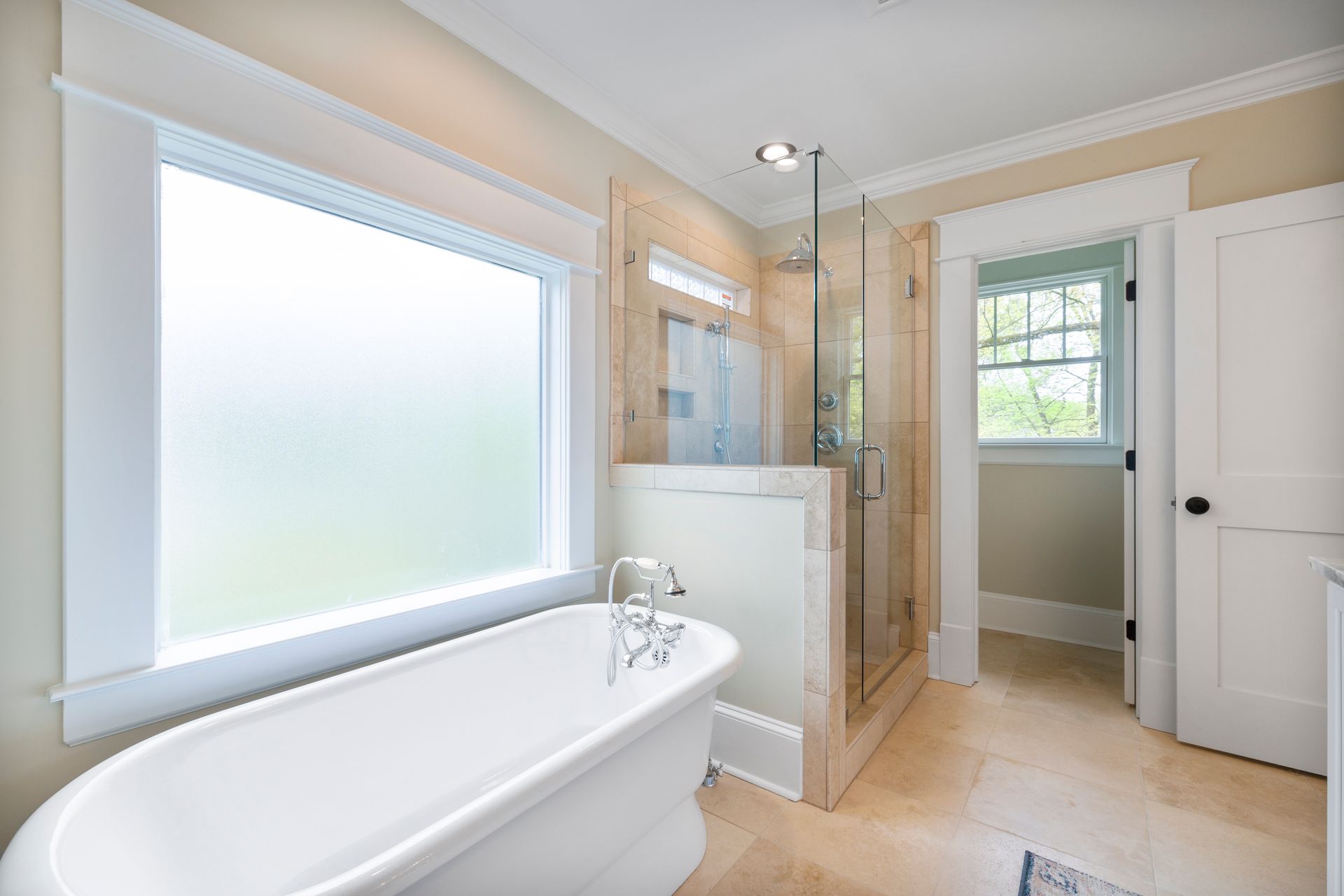 Bright and stylish modern bathroom featuring a freestanding tub and glass shower enclosure.