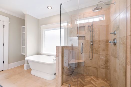 Elegant bathroom with freestanding tub and glass shower enclosure.