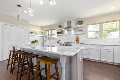 Free Spacious kitchen with marble countertops and modern appliances. Perfect for contemporary home designs. Stock Photo