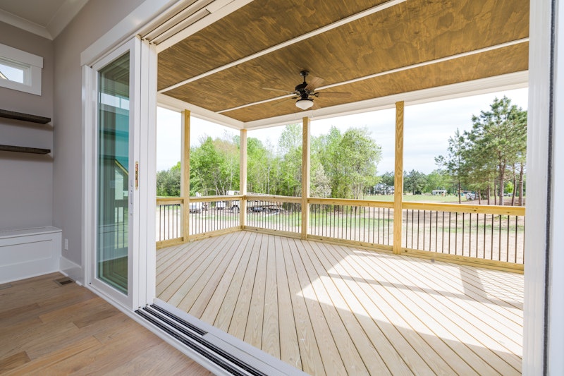 Covered veranda with composite decking, railing, and ceiling fan