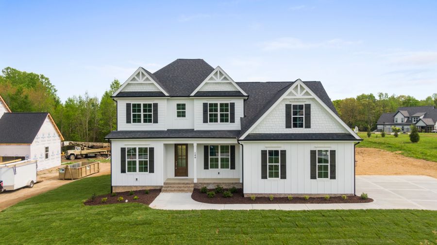 Single level suburban home with a landscaped lawn and paved walkway