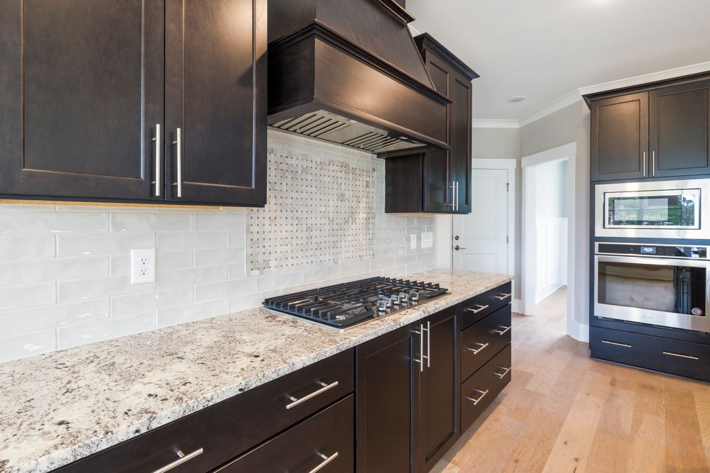 Stylish modern kitchen with granite countertop and dark cabinets