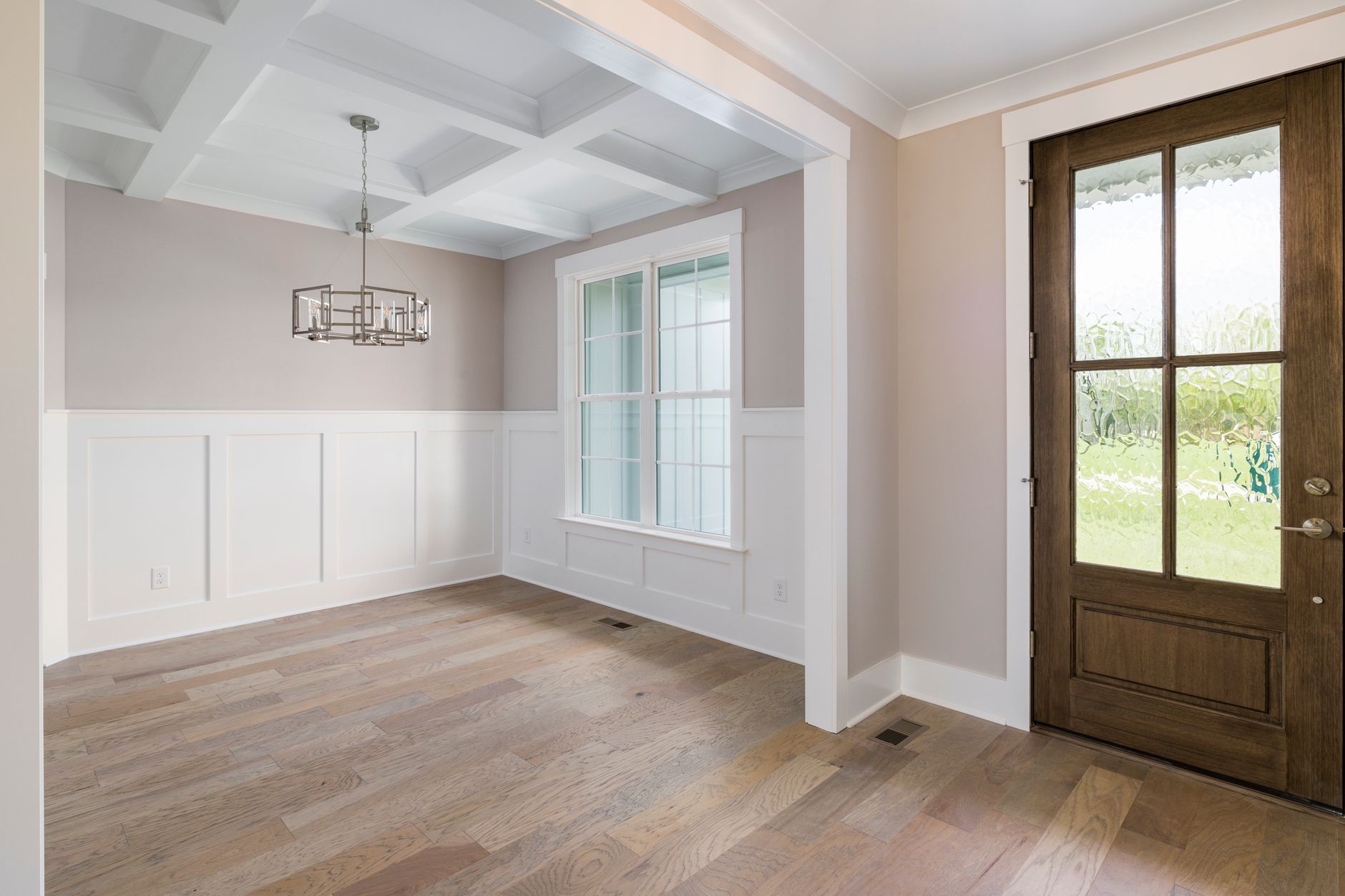 Modern interior with a wooden door and painted trim — choosing paint finishes and sheens in San Diego