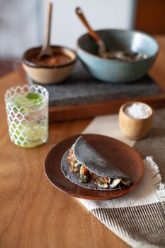 Delicious Mexican taco on a plate with a refreshing drink, perfect for a culinary journey.