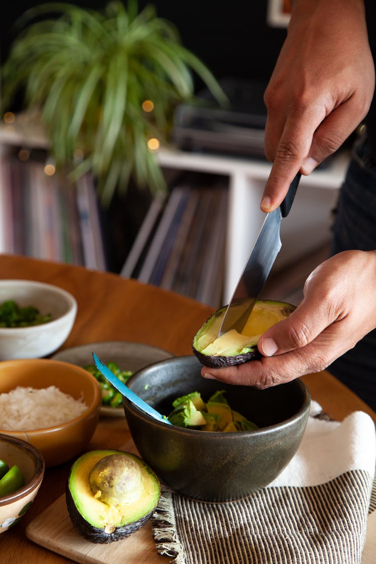 A Person Slicing Avocado